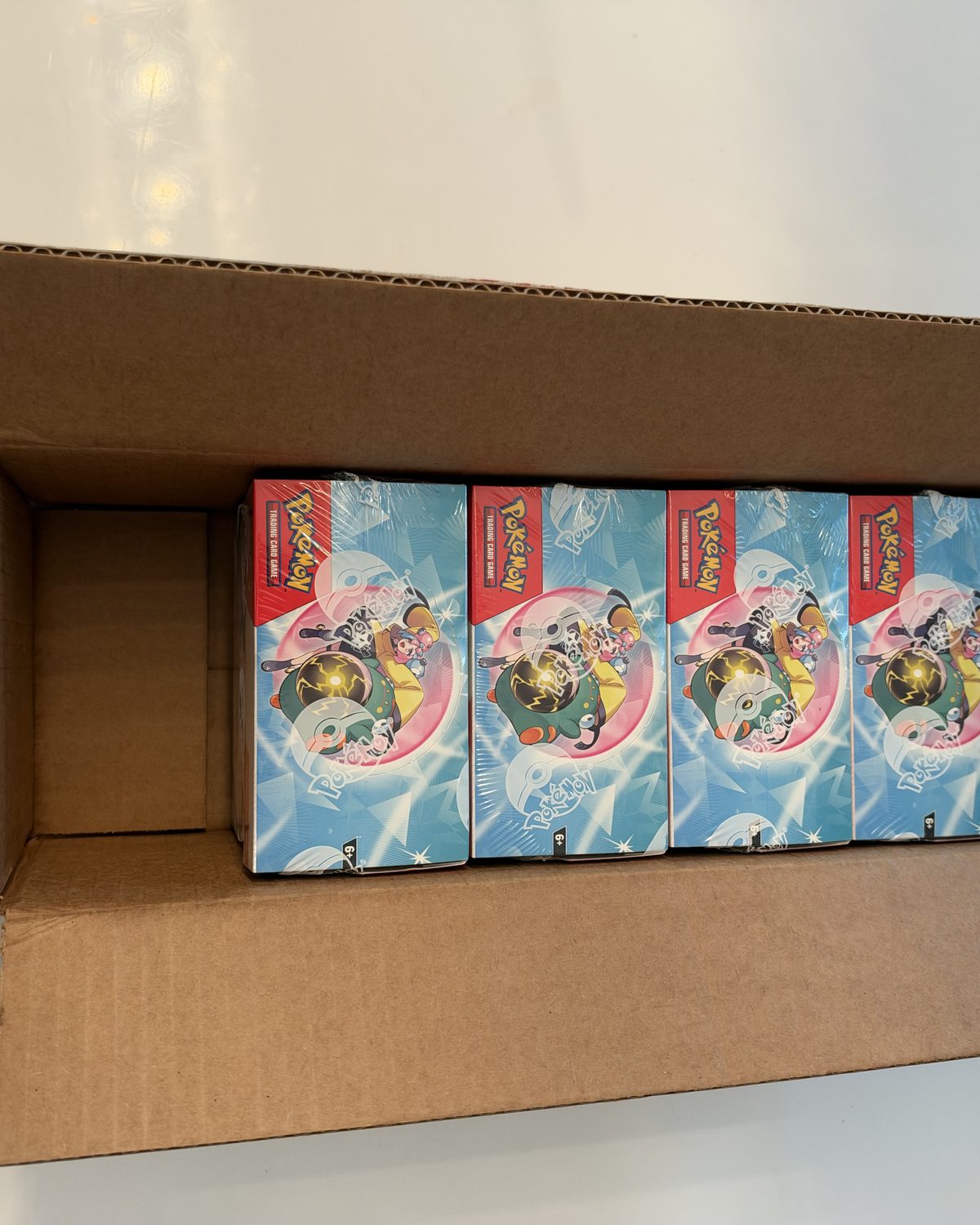 The case opened, booster boxes inside